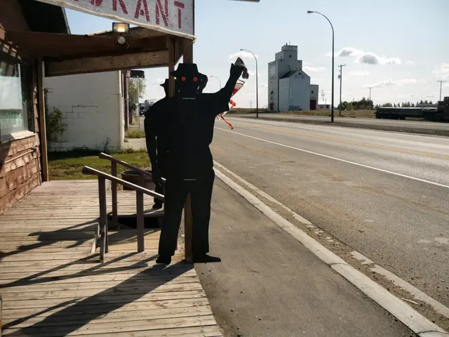 Plywood figure outside the restaurant, with grain elevator on Highway 11